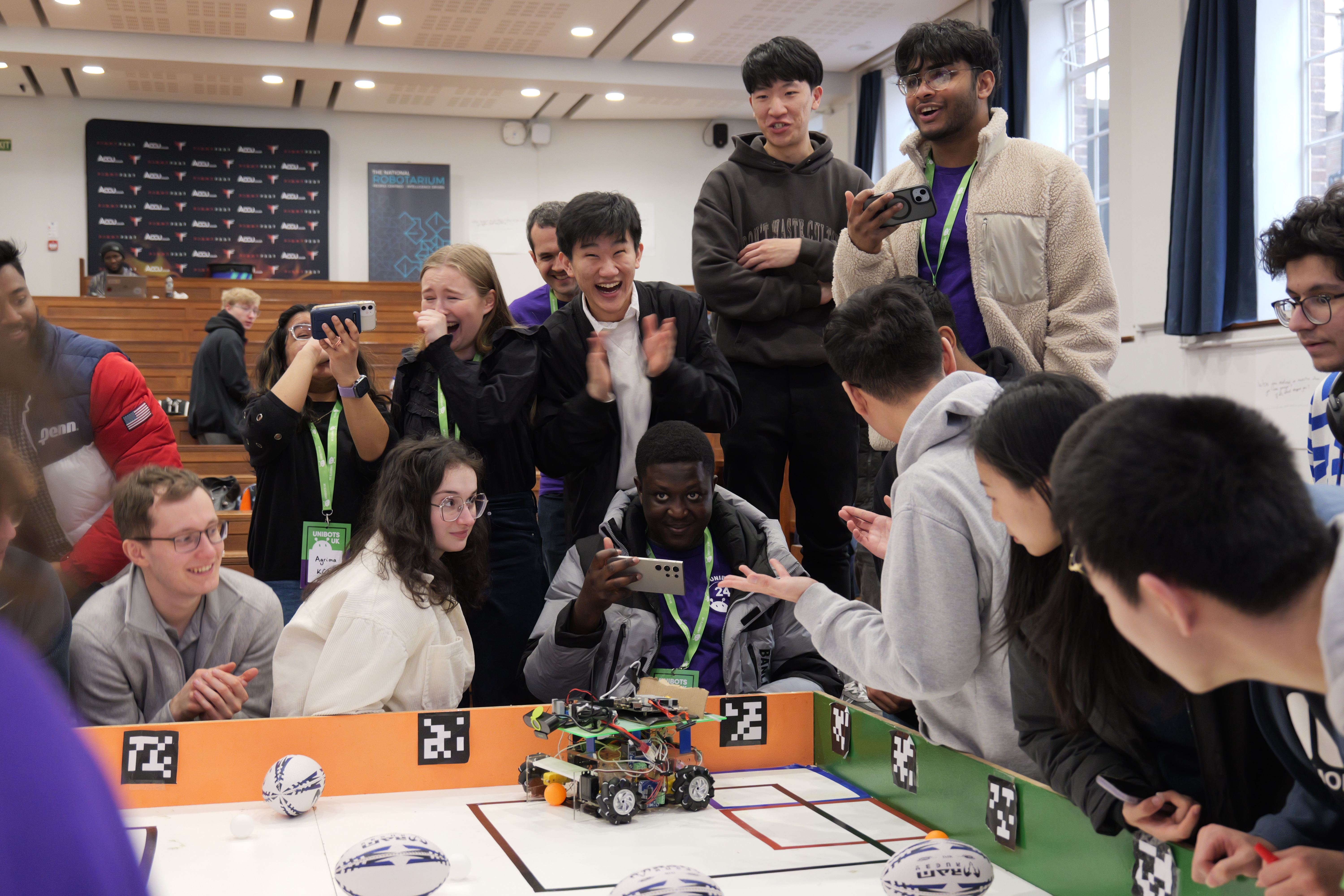 Students cheering as a robot competes in the arena
