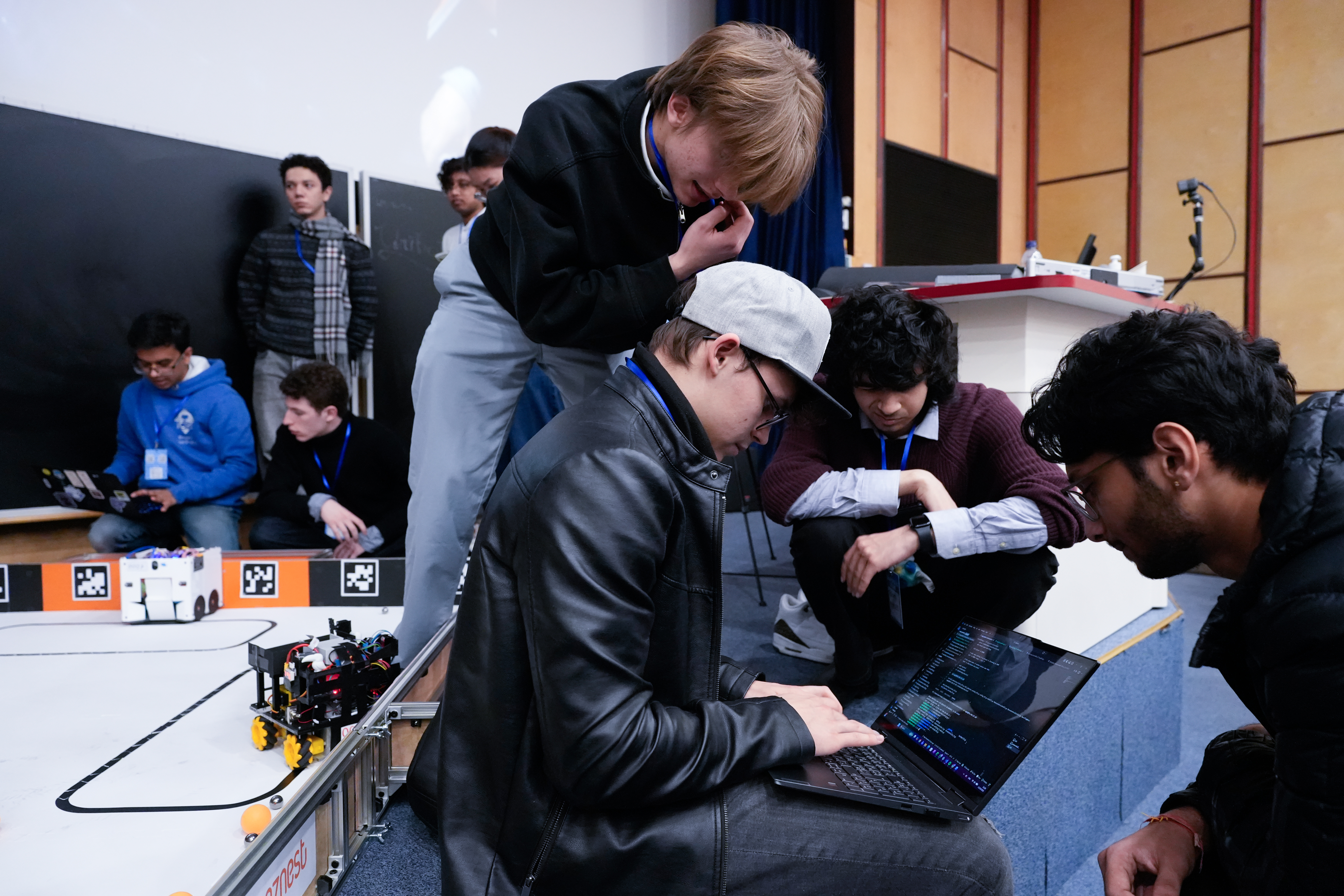 Students attending a talk at a Unibots event