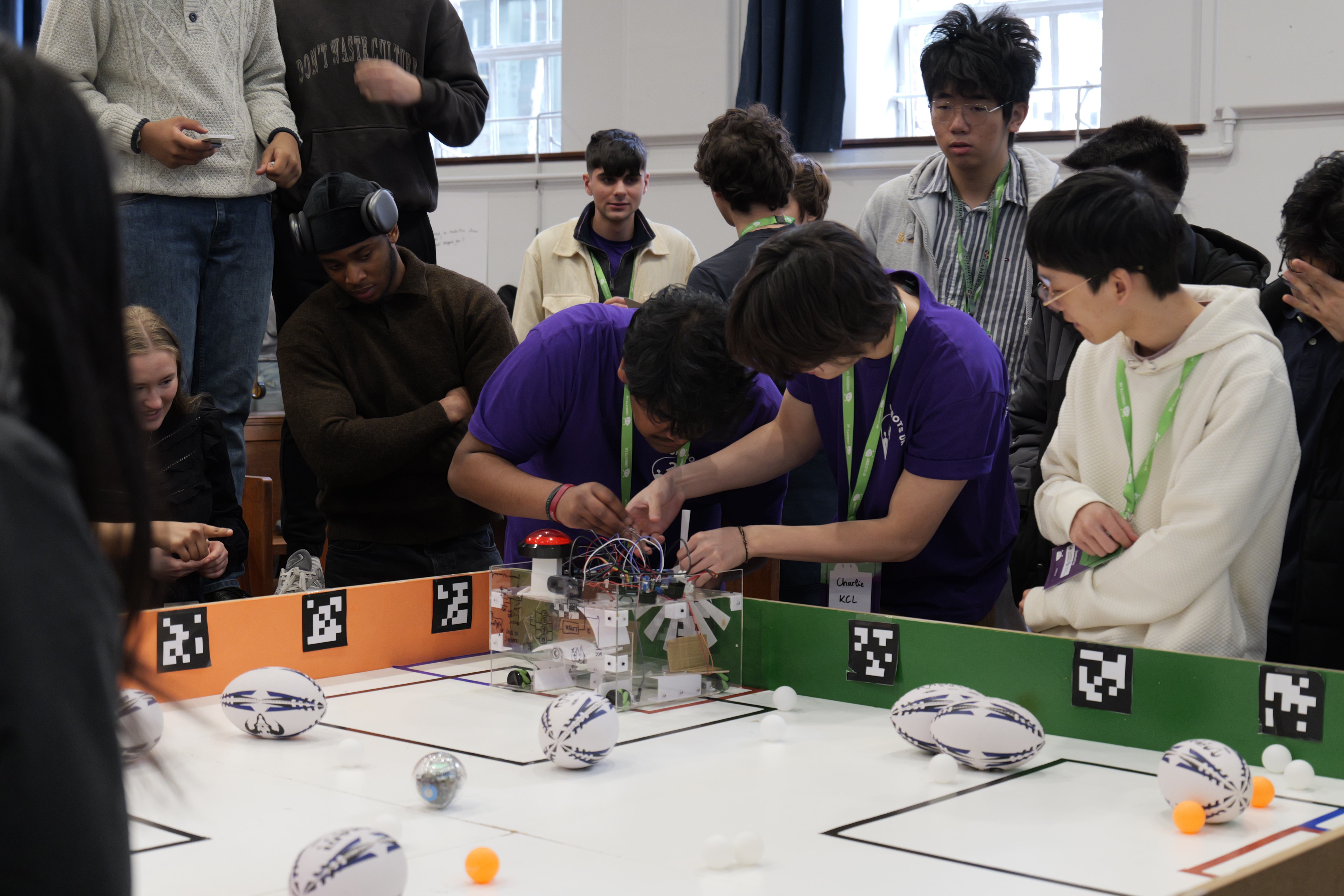 A student working on a robot at a Unibots event